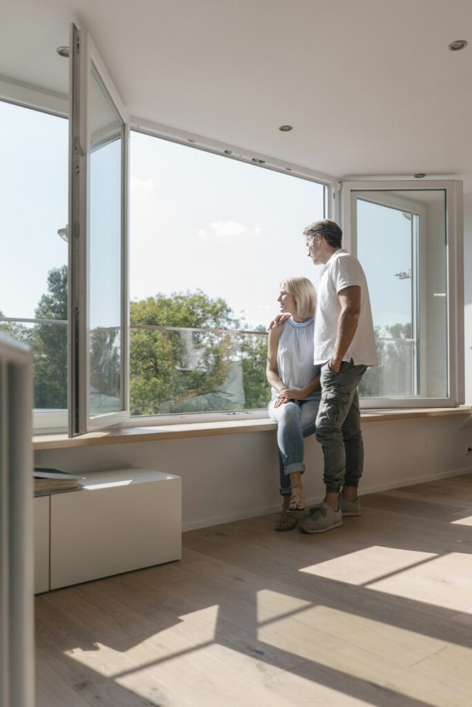 Mature couple at the window in empty room